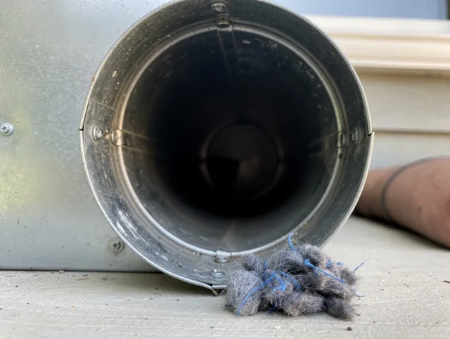 Hopkinton Dryer Vent Cleaning technician using specialized equipment to clear severe dryer vent blockage in Hopkinton